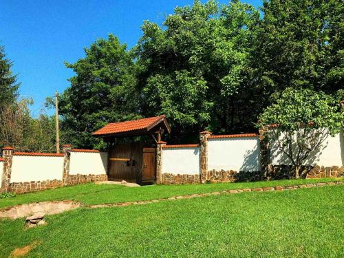 a fence with a gazebo in a yard at Къща за гости Диляна 