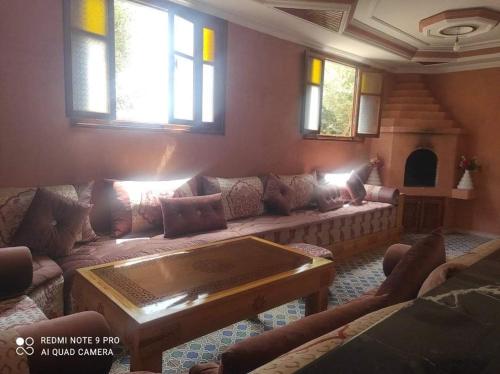 a living room with a couch and a table at Villa avec piscine in Essaouira