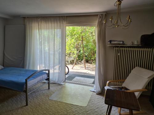 a bedroom with a bed and a sliding glass door at Eppstein in Eppstein