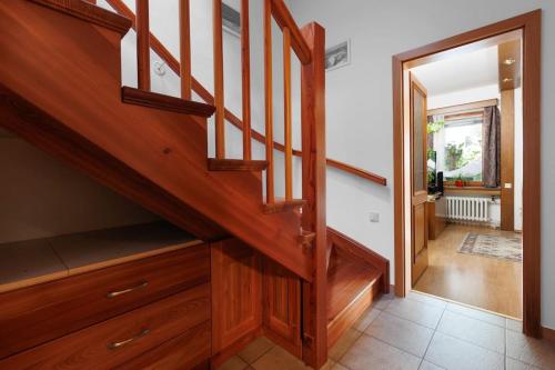 a wooden staircase in a home with a hallway at Entire house with garden near Prague in Benešov