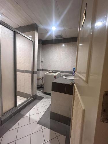 a bathroom with a sink and a toilet in it at Riverbank suites 405 in Kuching