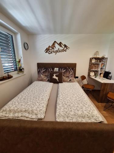 a bedroom with a large bed in a room at Bergliebe in Sankt Martin am Tennengebirge