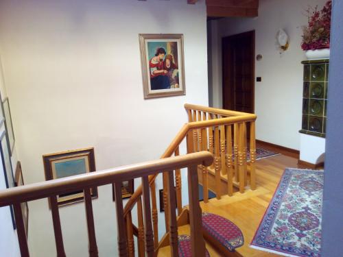 a staircase in a home with three pictures on the wall at B&B Casa Bazzanella in Cavalese