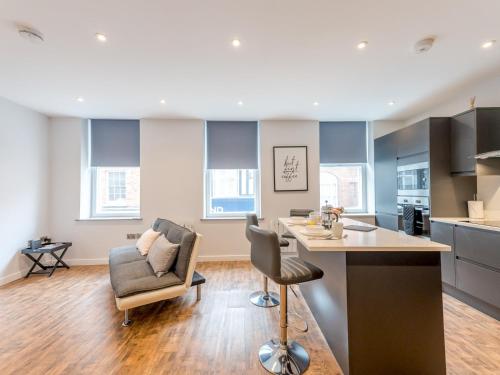 an open kitchen with a desk and chairs in a room at 5A One Bedroom Modern Town Centre Apartment - Pass the Keys in Shrewsbury