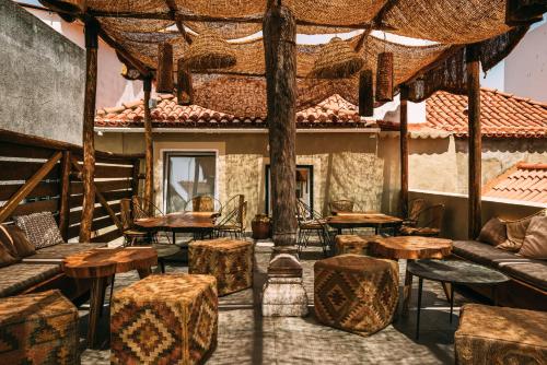 a room with tables and stools in a building at LEGASEA - Cascais Guesthouse in Cascais