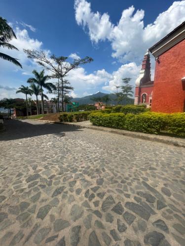 a cobblestone street in front of a church at Villa Venecia Colonial in Venecia