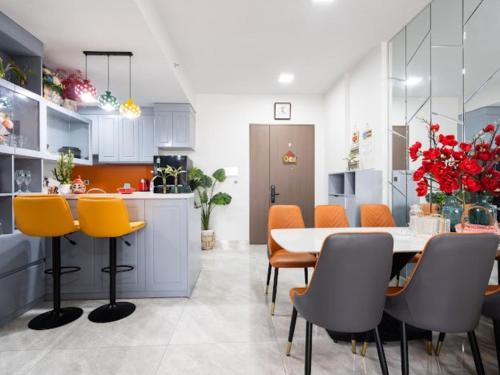 a kitchen and dining room with a table and chairs at Lalana Apartment in Ho Chi Minh City