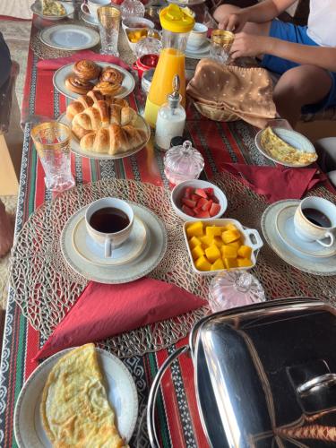 a table topped with plates of food on top at Starwatching Private Camp in Ḩawīyah