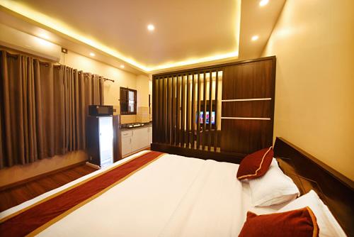 a bedroom with a large bed and a large window at Friends Apartment Pvt.Ltd in Kathmandu