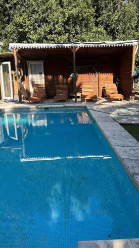 a large blue swimming pool in front of a house at Duplex 6 huéspedes , Piscina,acepta mascotas, Casa Mercurio LGBTQ friendly in Mar del Plata