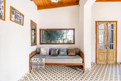 a couch sitting in a room with a window at Duplex 6 huéspedes , Piscina,acepta mascotas, Casa Mercurio LGBTQ friendly in Mar del Plata