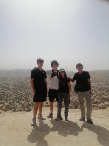 a group of people standing on top of a mountain at - Trekking from Dana to Petra in Dana