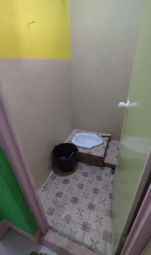a bathroom with a toilet in a room at Reza Kost in Karanganyar