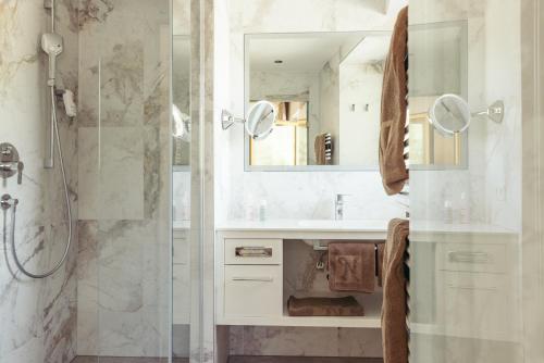a bathroom with a shower and a sink at Hotel Neuhintertux 4 Sterne superior in Tux