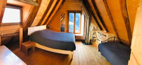 sypialnia z 2 łóżkami w drewnianym domku w obiekcie Chalet grange w mieście Bareilles