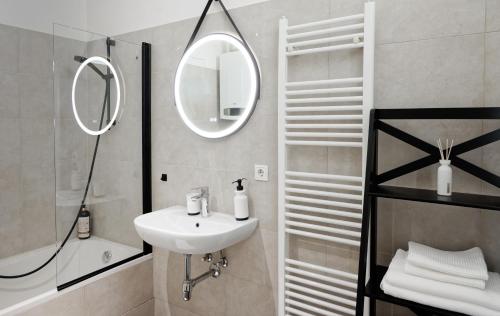 a white bathroom with a sink and a mirror at MINIMALISTIC STUDIO NEAR NASCHMARKT in Vienna