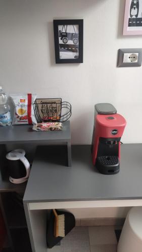 a table with a red coffee maker on it at Metro Station Mini Van CAPSULA House in Turin