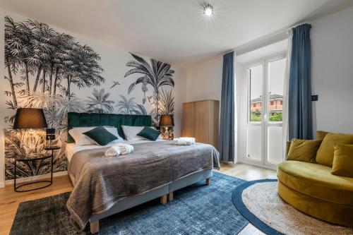 a bedroom with a large bed and a couch at Borgo Rotondo in San Giovanni in Persiceto