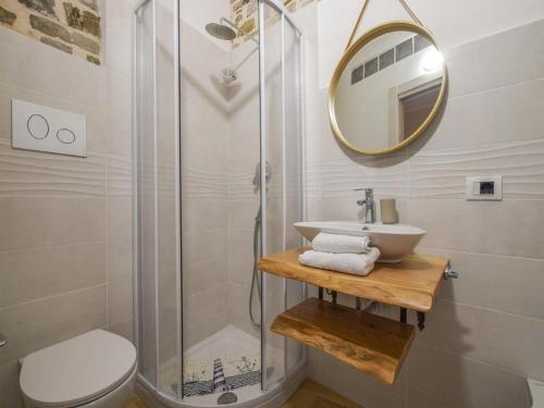 y baño con ducha, lavabo y espejo. en Cosy holiday home in Albidona near centre, en Albidona