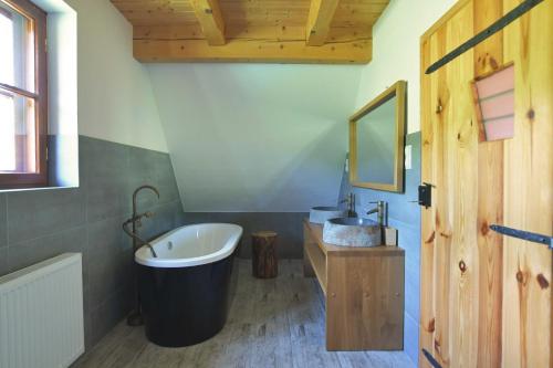 a bathroom with a large tub and a sink at Wilk u Drzwi in Ustrzyki Dolne