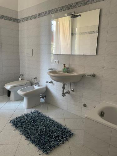 a bathroom with a sink and a toilet and a mirror at Dimora Montecchi in Verona