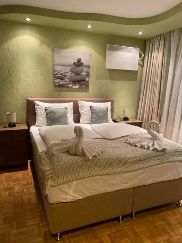 a bedroom with a bed with a stuffed animal on it at Eda Aparts in Devin