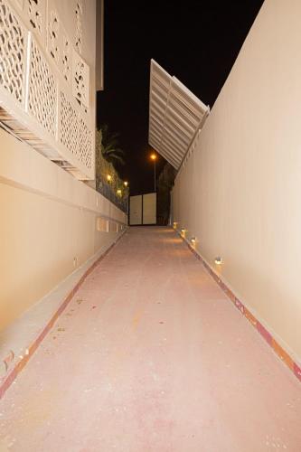 a walkway at night with lights on the side of a building at The Villa 604 Powered by look in Cairo