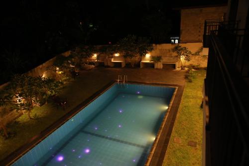 an overhead view of a swimming pool at night at Villa71 in Galle