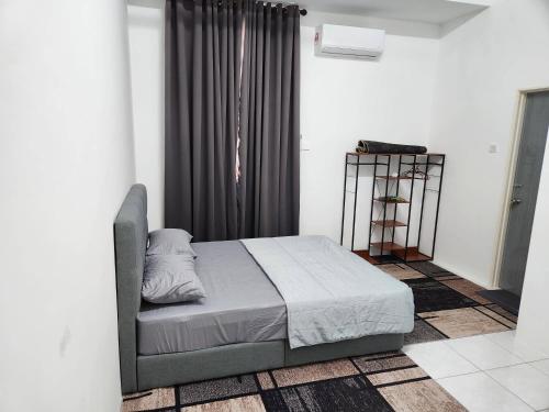 a bedroom with a bed and a black curtain at Pangeran Homestay Pokok Sena in Kampong Joo
