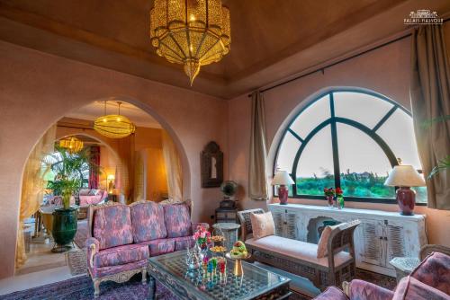 a living room with a couch and a table at Palais Hassoun Marrakech in Oulad Snaguia