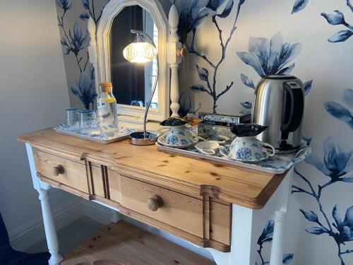 a dressing table with a mirror and a sink at Abbey Green Farm in Wem
