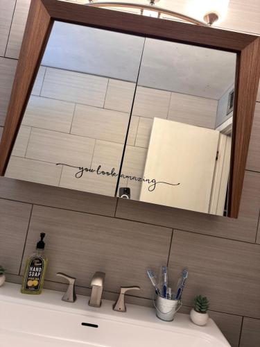 a mirror above a sink in a bathroom at Charming 2 Bed Mid-City Living only 7 Min to Downtown in Tucson