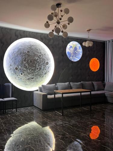 a living room with a couch and spheres on the wall at Hostel Orto Say in Bishkek
