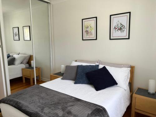 a bedroom with a bed with two pillows on it at Parkview Cottage in Henley Beach South