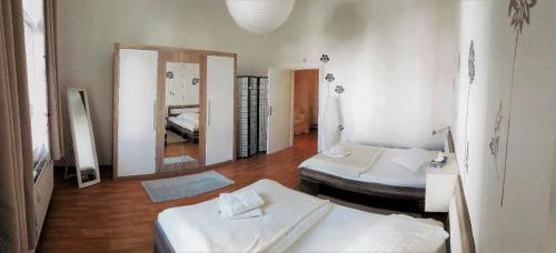 a living room with two beds and a mirror at Jugendstil Apartment in Bad Nauheim