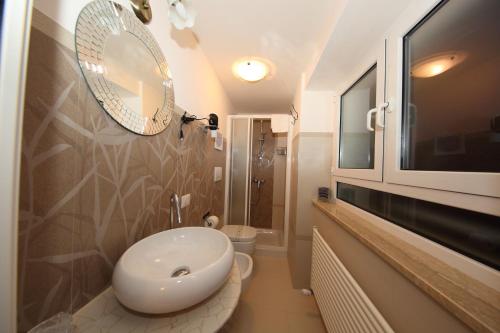 a bathroom with a white sink and a mirror at L'Isola di Esme in Rome