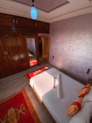 a bedroom with a bed and a mirror at Amouage Anza - Sea View Apartments in Agadir