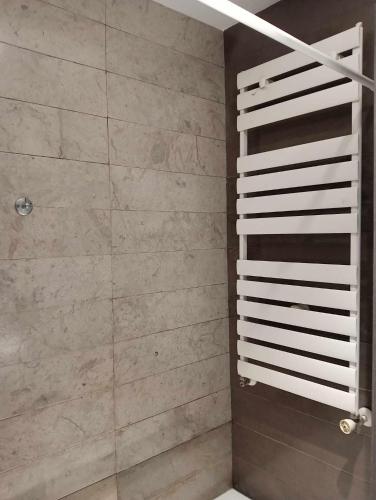 a bathroom with a shower with marble tiles at Le lagon de Hammamet in Hammamet