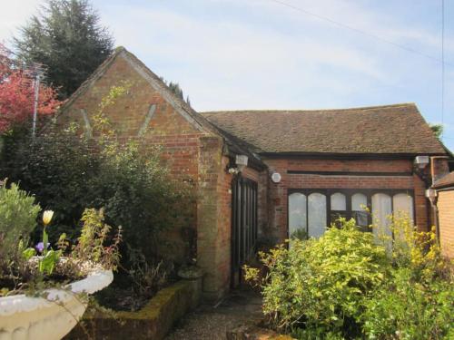 a small brick house with a garden in front of it at Barn conversion, Old Hatfield, Herts Just a few minutes walk to Hatfield train station and Hatfield House in Hatfield