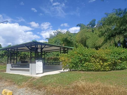 a pavilion with a sign in a park at Apartasol Amor y Café, Reserva de la Colina in La Tebaida