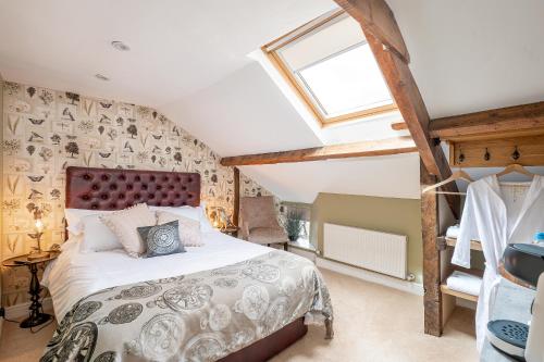 a bedroom with a bed and a window at No93 Boutique Guest House in Easingwold