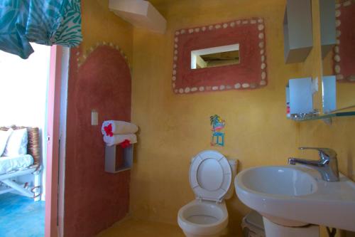 a bathroom with a toilet and a sink at B&B Aparthotel La Isleta in Las Galeras