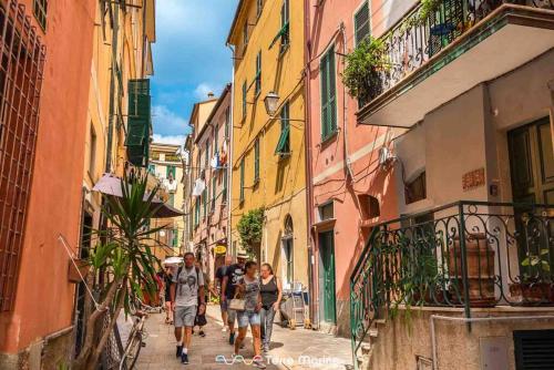 a group of people walking down a street at XX di Mare, Terre Marine in Monterosso al Mare