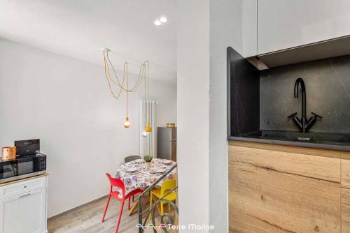 a dining room with a table and a tv in a kitchen at XX di Mare, Terre Marine in Monterosso al Mare