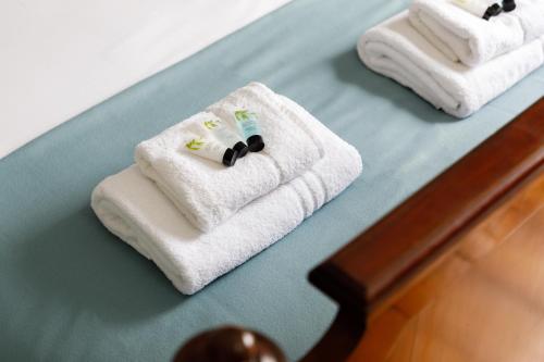 three towels sitting on a table in a room at Artists' Home - North Laine in Brighton & Hove