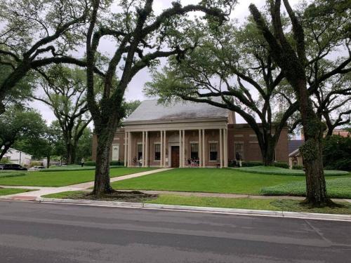 a large building with trees in front of it at Gingerbird Art Suite in Laurel