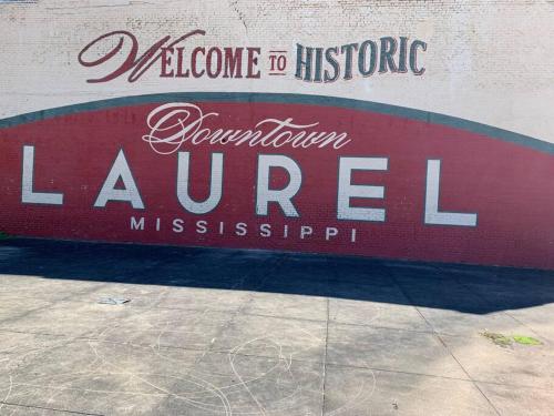 a sign for the entrance to a store at Gingerbird Art Suite in Laurel
