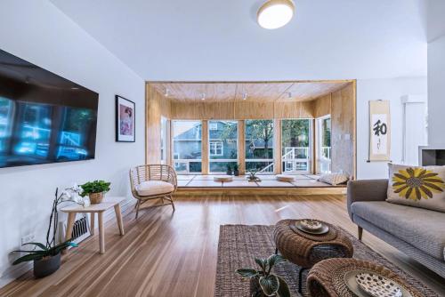 a living room with a couch and a table at Three-Tree Villa-Central Location in Vancouver
