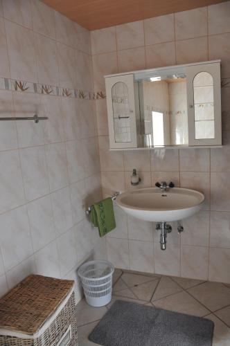 a bathroom with a sink and a mirror at Altes Bauernhaus in Gnesau