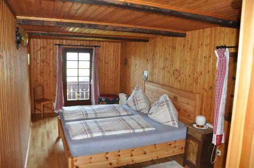 a bedroom with a bed in a wooden room at Altes Bauernhaus in Gnesau